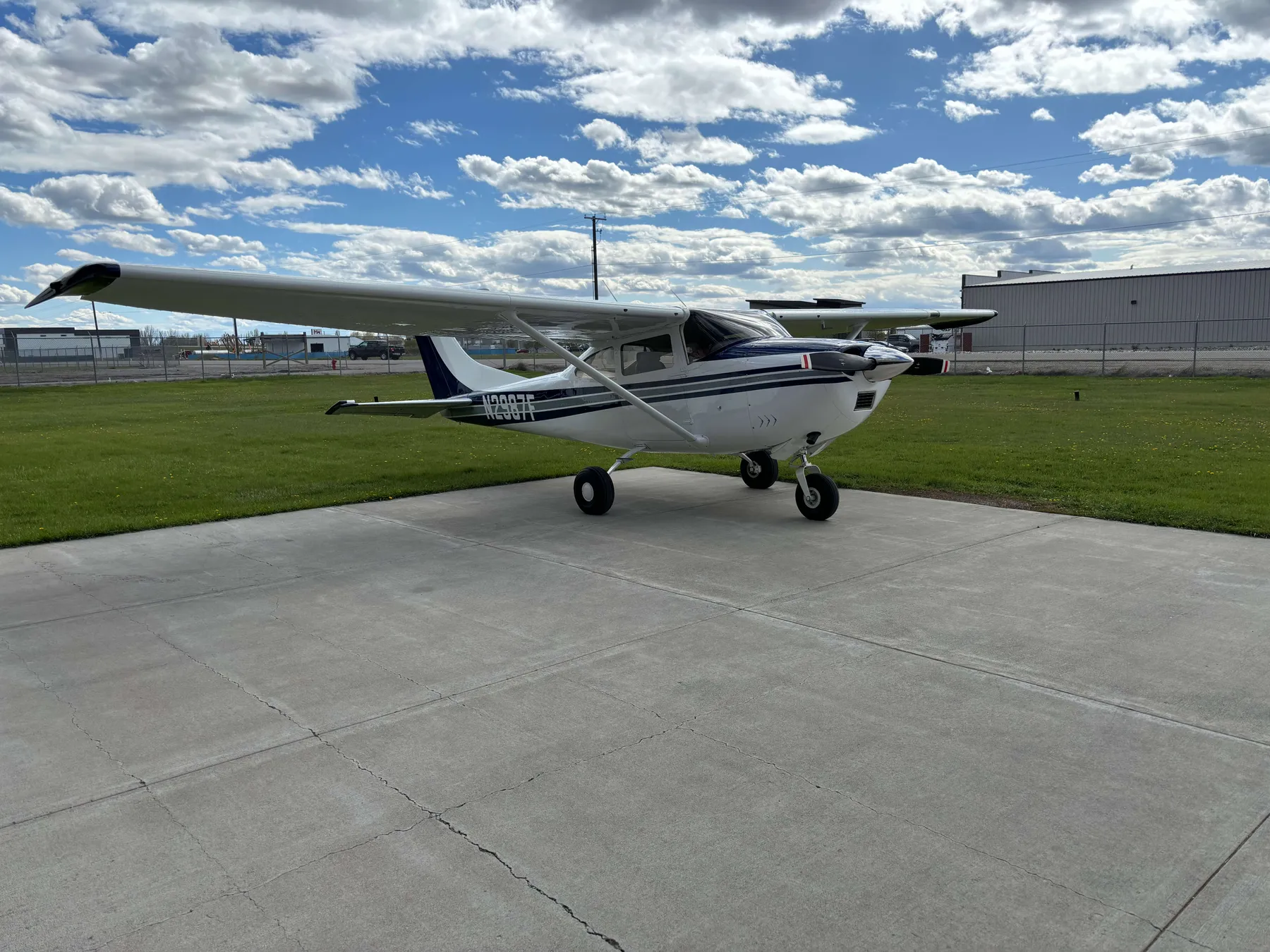 N2987F, a blue and white 1966 Cessna 182J, viewed from the front left on the ramp